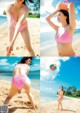 A woman in a pink bikini playing with a beach ball.