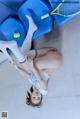 A woman laying on the floor with a tennis racket.